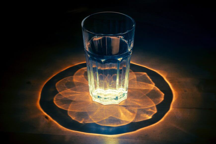 design created by light traveling through water glass